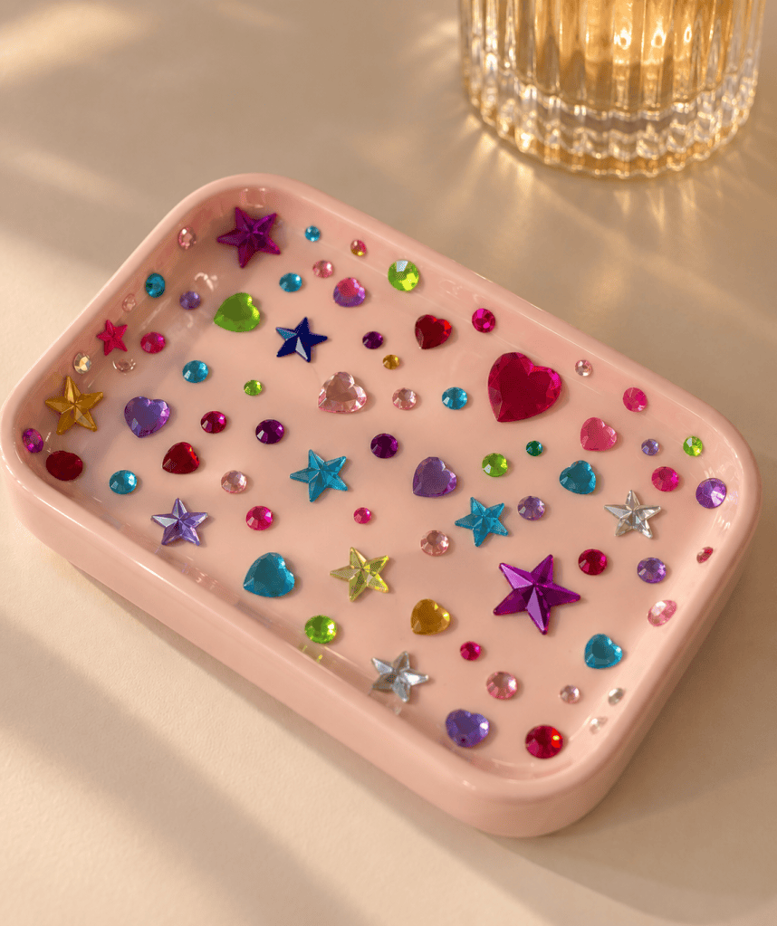 Trinket tray decorated with colorful rhinestones and gems, a cute bedazzled DIY craft idea for jewelry storage, gifts, or vanity decor.